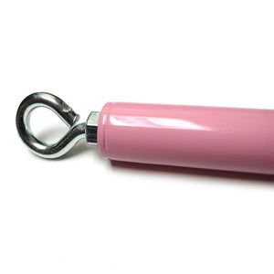A closeup of the metal eyehole on the end of the Pink Adjustable Spreader Bar is shown against a blank background.