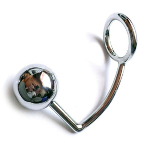 The silver stainless steel Trailer Hitch is displayed against a blank background. A hooked piece of steel has an anal plug ball on one end and a cock ring on the other.