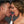 Load image into Gallery viewer, A close-up of a man and a woman leaning in like they are going to kiss. There is a Neon Wand between them with a red, glowing KinkLab Tongue Neon Wand Attachment inserted. Both of their tongues are touching the attachment.
