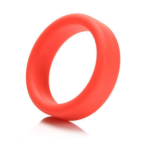 A Tantus Super Soft C-Ring in red is displayed against a blank background. It is a ring made of a thick band of matte red silicone.