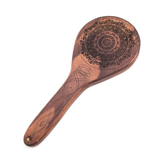The Floral Engraved Wood Spanking Paddle, a light brown wooden ping-pong style paddle with a floral design engraved on it, is displayed against a blank background.