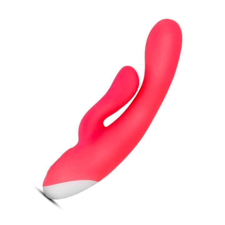 The Cerise Hop Trix Rabbit Vibrator is shown against a blank background. It is made of bright pink silicone with a small white spot at the base. It has a smooth, curved insertable portion with a smaller projection from the base for clitoral stimulation.
