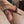Load image into Gallery viewer, A close up of a man’s penis is shown with one red Electrastim Electraloop Prestige fastened around his balls and one behind the head of his penis.
