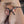 Load image into Gallery viewer, A close up of a man’s penis is shown with one silver Electrastim Electraloop Prestige fastened around his balls and one behind the head of his penis.
