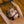 Load image into Gallery viewer, A naked woman with dirty blonde hair lays on her back on a wooden floor with her arms connected to a wrist spreader bar above her. She is wearing the Silicone O-Ring Bondage Mouth Gag, which holds her mouth open and allows her tongue to poke through the ring.
