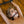 Load image into Gallery viewer, A naked woman with dirty blonde hair lays on her back on a wooden floor with her arms connected to a wrist spreader bar above her. She is wearing the Silicone O-Ring Bondage Mouth Gag, which holds her mouth open and allows her tongue to poke through the ring.
