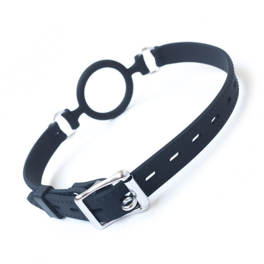 The Silicone O-Ring Bondage Mouth Gag is shown from the back against a blank background. The gag’s strap is fastened with an adjustable metal buckle.