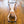Load image into Gallery viewer, A nude blonde woman wearing a gag is shown laying on a wooden floor with her arms raised above her head. Her wrists are locked in the black Big Barrel 12 Inch Wrist Spreader Bar With Cuffs, and her ankles are locked in a matching ankle spreader bar.
