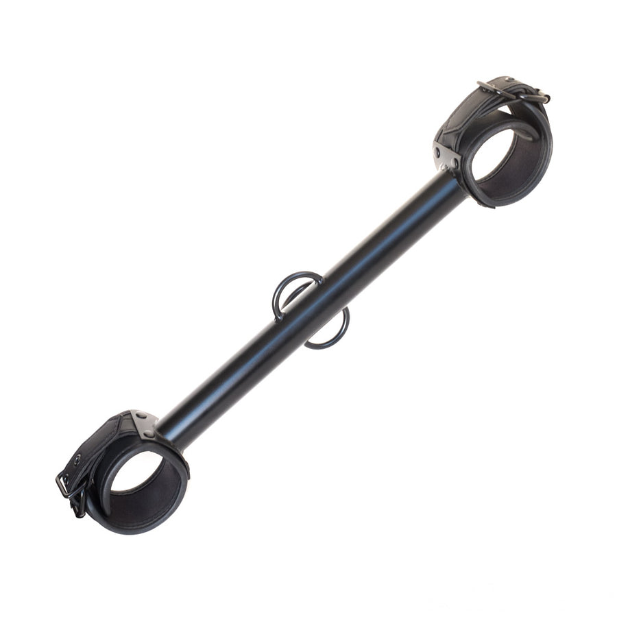 The black Big Barrel 12 Inch Wrist Spreader Bar With Cuffs is displayed against a blank background. The metal bar is thick and has three welded loops in the center. The bar has a black buckling neoprene cuff attached to each end.