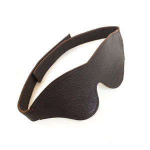 The BDSM Classic Cut Brown Leather Blindfold is displayed against a blank background. The strap has a velcro closure in the back.