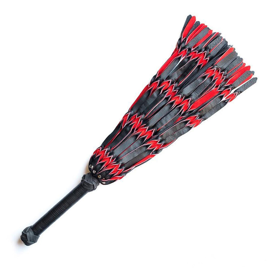 The red and black Braided Leather Flogger is displayed against a blank background. The flogger’s falls are made of strips of black and red leather braided together. The handle is long and cylindrical with knots of braided leather and both ends.