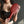 Load image into Gallery viewer, A close-up of a woman wearing a black latex tank top and holding the Saffron Ping Pong Paddle in front of her chest.
