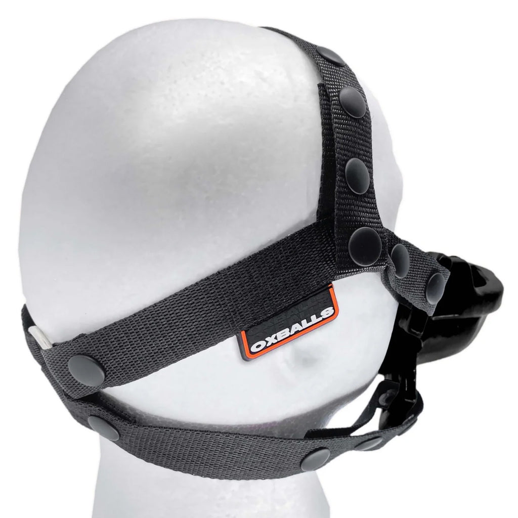 The black Watersport Mouth Gag With Adjustable Nylon Straps from Oxballs is displayed on a mannequin against a blank background.