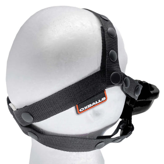 The black Watersport Mouth Gag With Adjustable Nylon Straps from Oxballs is displayed on a mannequin against a blank background.