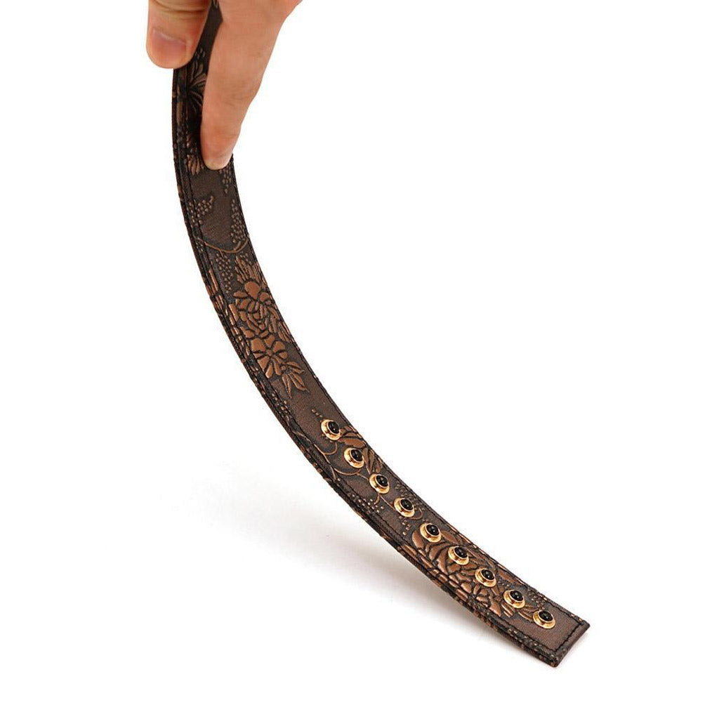 The Vegan Floral Ruler With Gems is shown being bent by somebody against a blank background, displaying its flexibility.