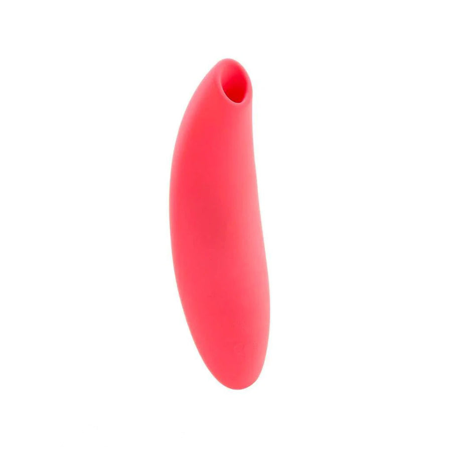 The We-Vibe Melt Pleasure Air Clitoral Vibrator in Coral is shown from the front against a blank background. From a forward angle, the toy is oval shaped.