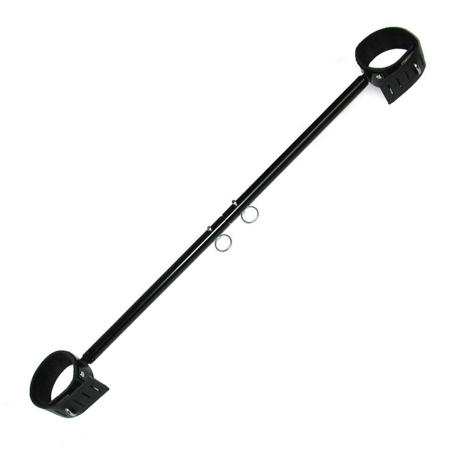 The black Adjustable Wrist And Ankle Spreader Bar is displayed against a blank background. It is a black metal rod with silver pins that can be moved to adjust the length of the bar. The bar has a lockable black leather cuff on each end.