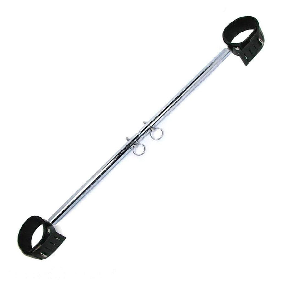 The chrome Adjustable Wrist And Ankle Spreader Bar is displayed against a blank background. It is a silver metal rod with silver pins that can be moved to adjust the length of the bar. The bar has a lockable black leather cuff on each end.