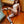 Load image into Gallery viewer, A nude woman with red hair sits on a wooden floor, leaning back against a wood post. One of her legs rests on the ground and the other is above it in the air. They are spread apart by the black Adjustable Wrist And Ankle Spreader Bar.
