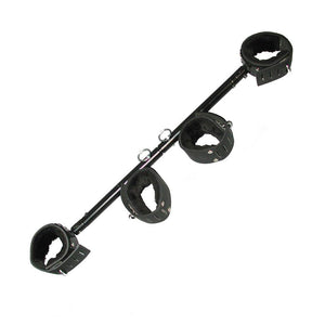 The black Adjustable Stocks are shown against a blank background. It is a black rod with two metal pins that can be moved to adjust the length of the bar. There are two black leather fleece-lined cuffs on each end and two in the middle.