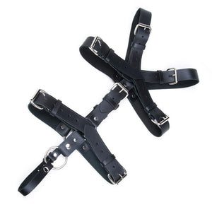 The Leather Torso Harness is displayed from the front against a blank background. It is made of black leather with silver hardware. The straps are adjustable and secured with buckles.