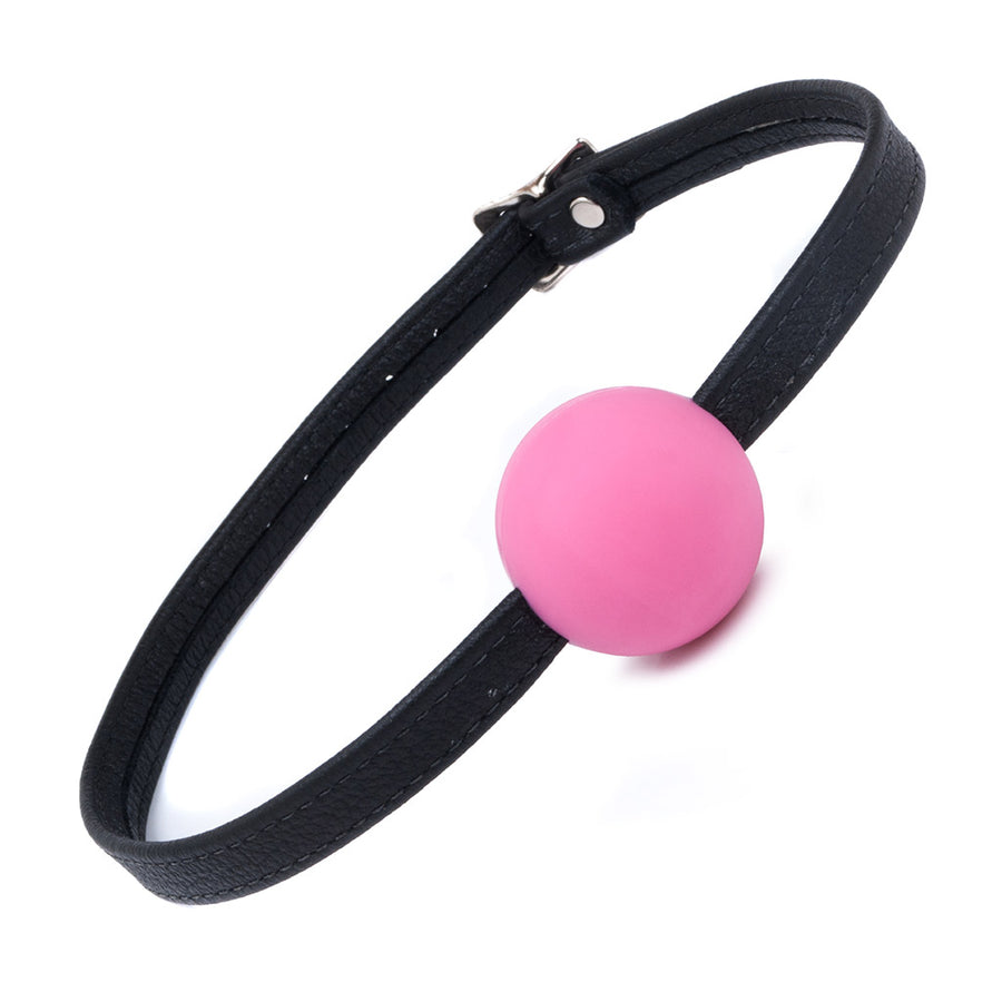 The pink Silicone Ball Gag With A Garment Leather Strap is displayed against a blank background. It is a medium-sized light pink ball made of matte silicone with a thin, adjustable black leather strap.