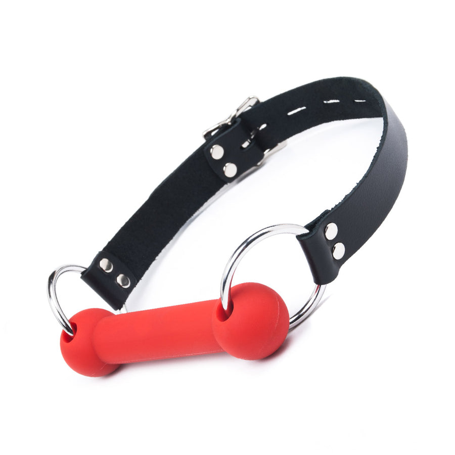 The Silicone Bit Gag in red is displayed against a blank background. The bit is red, and the straps are black.