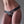 Load image into Gallery viewer, A nude woman is shown wearing the Vanity Strapon Dildo Harness, made of black leather. The strapon has a pentagon shape in the center with a hole for a dildo. The sides have 3 straps that merge into one and are fastened at the hips with silver buckles.

