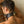 Load image into Gallery viewer, A close-up of the back of a brunette man’s head is shown, leaning his forehead against a brick wall. He wears the black leather Posture Collar with a Silicone Ball Gag, which is locked shut with a brass padlock.
