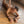 Load image into Gallery viewer, A naked woman wearing the Stupid Cute Blindfold lays on her stomach on a wooden floor. Her arms are in front of her, and her knees are bent with her feet in the air. She is wearing matching wrist and ankle cuffs, which are connected by restraint clips.
