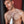 Load image into Gallery viewer, A shirtless man with dark hair, facial hair, and chest hair stands against a red and black background. He holds the wand with the electrode comb from the Kinklab Neon Wand® Electrosex Kit.
