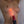 Load image into Gallery viewer, A close-up of a woman&#39;s bare torso is shown. Somebody holds a red Neon Wand up to her torso with the KinkLab Heart-On Neon Wand Electroplay Attachment on it, which glows red. The wand grazes her breast.
