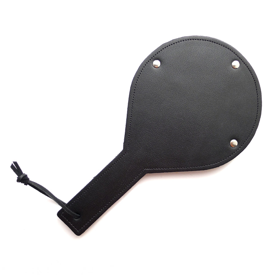 The Black Leather Gentle Persuasions Paddle is shown against a blank background with the leather side up. The entire paddle is covered in smooth black leather.