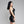 Load image into Gallery viewer, A woman with black hair and red lipstick poses in profile in front of a grey background. She wears the Latex Halter Dress in black from Syren Latex.
