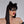 Load image into Gallery viewer, A headshot of a woman with dark hair and red lipstick posed in front of a grey backdrop. She wears the black Mistress Mask by Syren Latex, which outlines her eyes in a cat-eye style. She also wears black latex kitten ears. 
