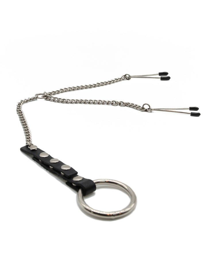 The Tweezer Clamps/Cock Ring Set is displayed against a blank background. The silver tweezer clamps are attached to a Y-shaped chain, which connects to a leather strap with a metal cock ring at the bottom.