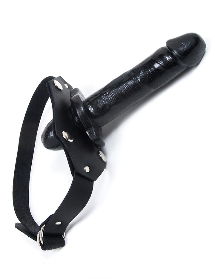The black In And Out Penis Gag With A Removable Dildo is displayed against a blank background. The gag is made of a black double-ended dildo with black leather straps.