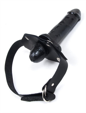 The black In And Out Penis Gag With A Removable Dildo is displayed against a blank background. Only the head of the dildo is pushed through to the interior of the gag, with most of the dildo on the outside.