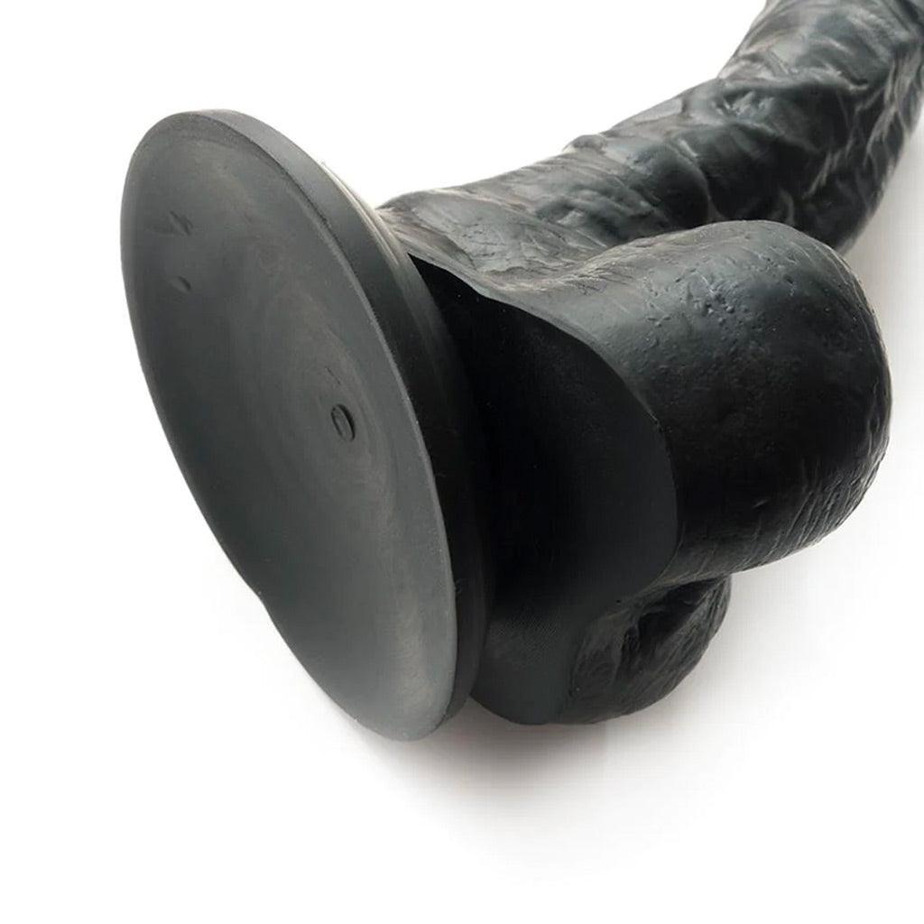 A closeup of the suction base of the Colours 8" Silicone Black Dildo is shown against a blank background.