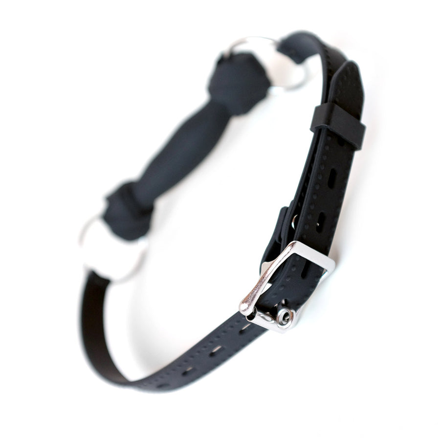The Silicone Bone Gag with a Silicone Strap is shown from behind against a blank background. The strap is adjustable and closes with a lockable metal buckle.
