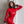 Load image into Gallery viewer, A woman with curly shoulder-length brown hair stands in front of a white wall with her hand behind her head. She is wearing a bright red latex catsuit. She also wears the Silicone Locking Collar and matching wrist cuffs.
