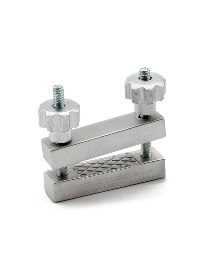 One Extreme Adjustable Nipple Clamps is shown assembled against a blank background. Two aluminum jaws are on top of each other with a little space between them. They are supported by a bolt and nut on each side.