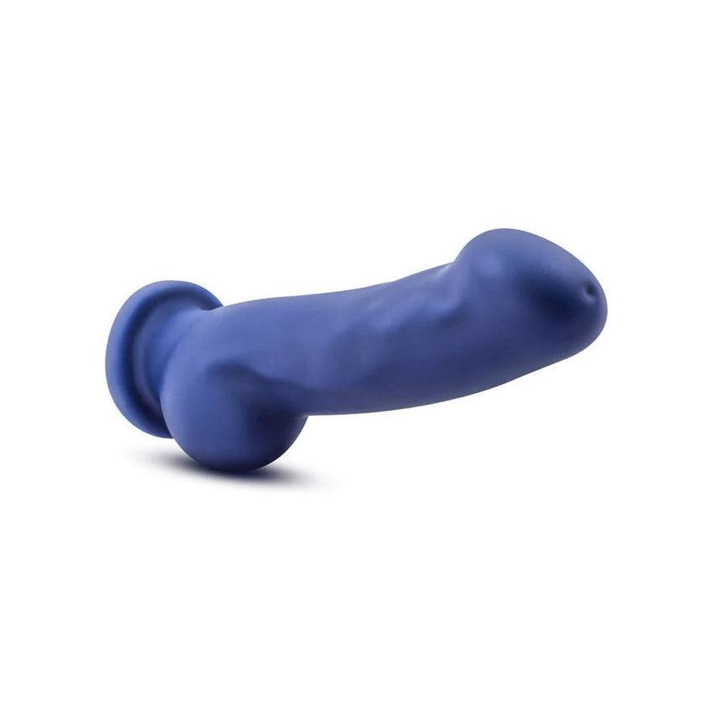 The Avant Ergo Dildo on a white surface and background, balanced on the testicles to show a horizontal view. 