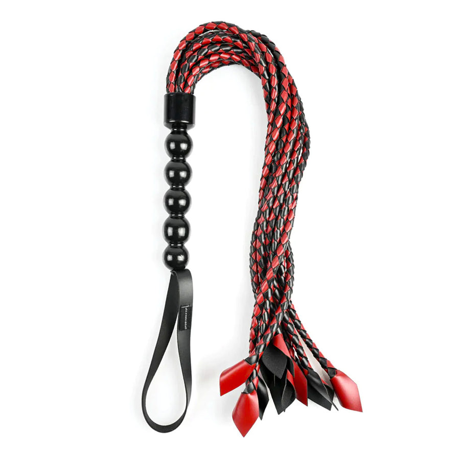 The Saffron Braided Flogger is shown against a blank background. It is a red and black BDSM impact play tool.