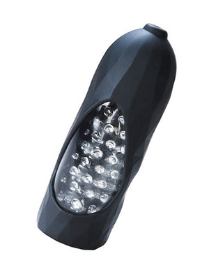 The VeDO Hummer Max Stimulation Vibrating Sleeve is shown against a blank background. It is a black silicone cylinder with a clear window in the middle, showing the translucent textured interior of the masturbator.