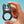 Load image into Gallery viewer, A hand is shown holding up the Fun Factory Nōs Vibrating Cock Ring against a light blue background.
