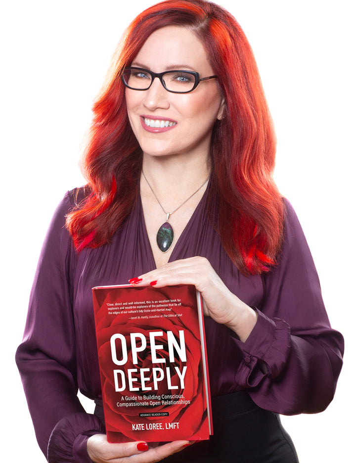 Kate Loree, the author of Open Deeply, is shown presenting the book. She has bright red hair and nail polish and is wearing black rimmed glasses and a dark purple blouse. 