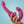 Load image into Gallery viewer, A woman’s hand is shown holding up a Fun Factory Share Lite Double Dildo in Blackberry against a light blue background.
