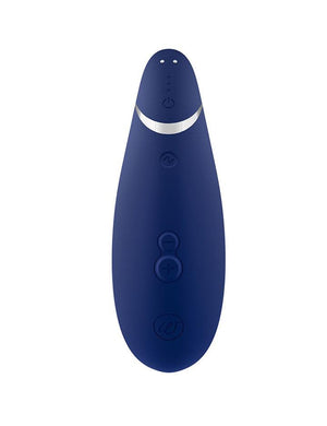 The Blueberry Womanizer Premium 2 is shown from the back against a blank background. Its three buttons and magnetic charging ports are visible.