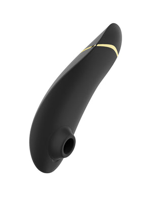 The Blueberry Womanizer Premium 2 is shown from the back against a blank background. Its three buttons and magnetic charging ports are visible.